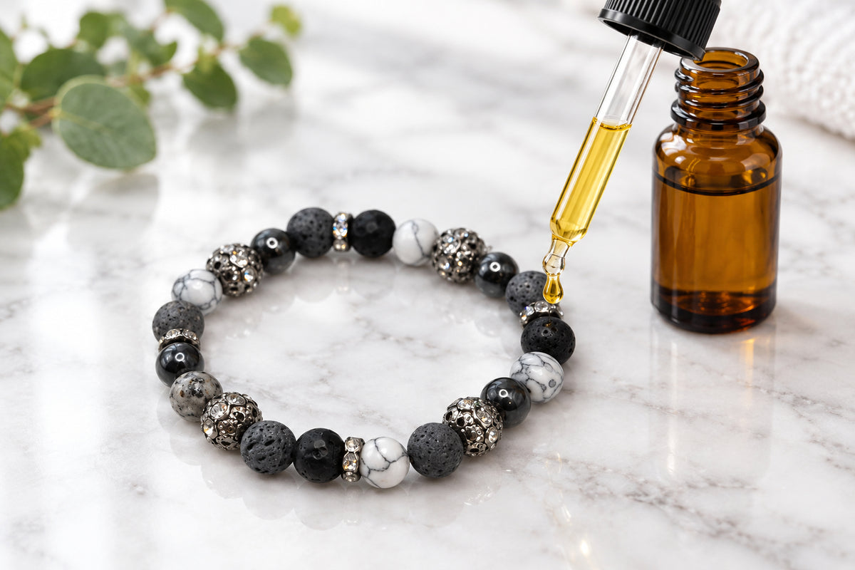 A beaded stretch bracelet featuring a mix of matte black, textured gray, metallic silver, and white marble beads, displayed on a neutral light gray background.