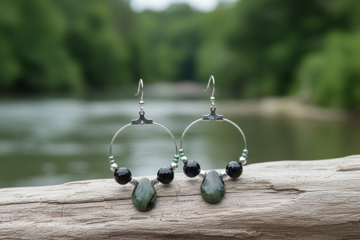 A pair of silver hoop earrings with a Kambaba Jasper bead and two tourmaline beads, displayed against a white background.