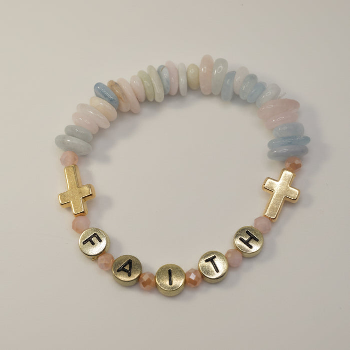 Bracelet with colorful beads and gold crosses on a light gray background