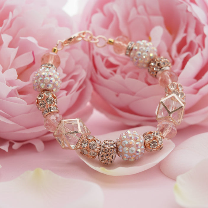 Elegant bracelet with decorative beads on a pink floral background