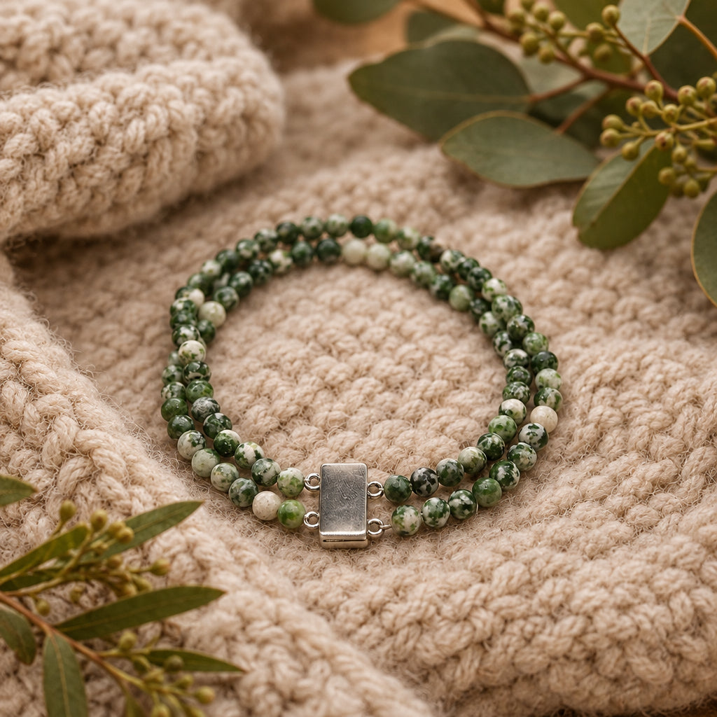 A double-strand beaded necklace made of green and white marbled beads with a rectangular silver clasp, displayed on a light gray background.