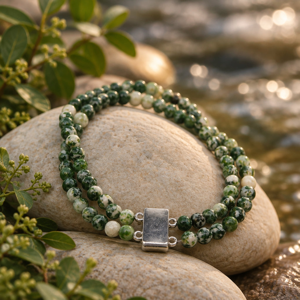 A double-strand beaded necklace made of green and white marbled beads with a rectangular silver clasp, displayed on a plain light gray background.
