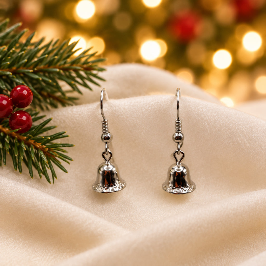 A pair of silver bell-shaped dangle earrings hanging from silver fishhook wires, displayed against a light gray background.