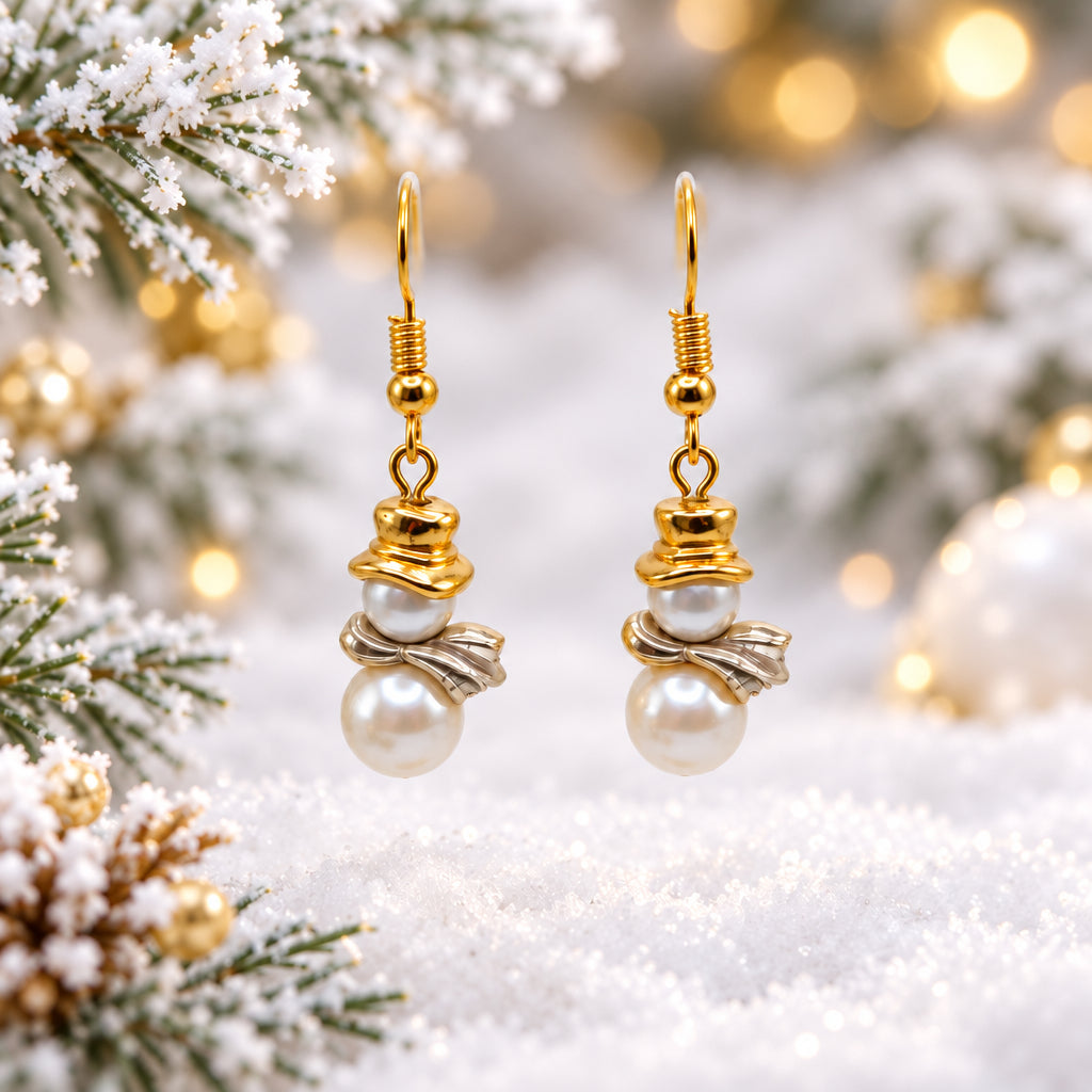 A pair of gold dangle earrings with twisted gold wire details and white pearl drops, displayed on a clear acrylic stand against a neutral gray background.