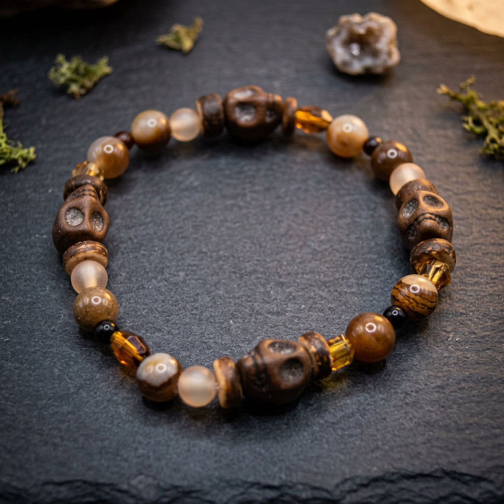 A beaded stretch bracelet featuring carved brown wooden beads, smooth beige agate-like beads, and translucent amber glass beads, arranged in a circle on a light gray background.
