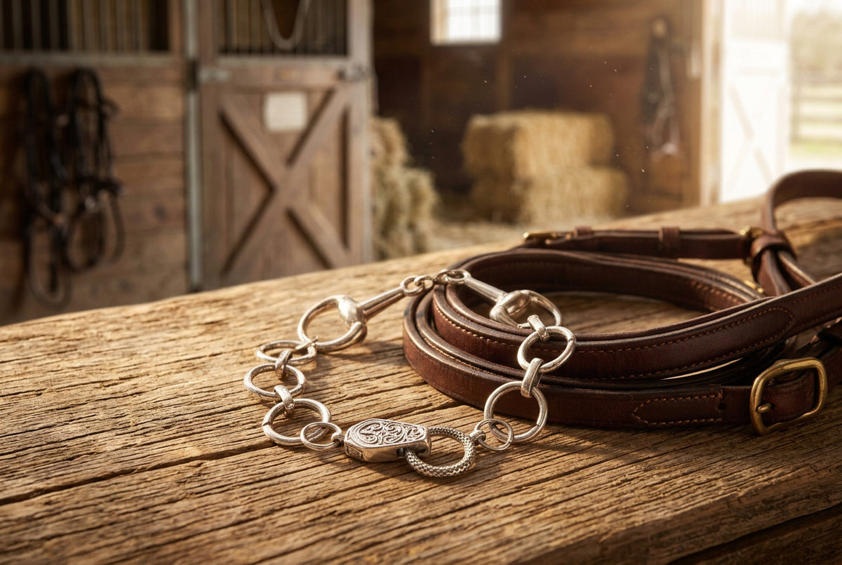 A silver-toned chain bracelet with a central decorative clasp, photographed on a plain light gray background.