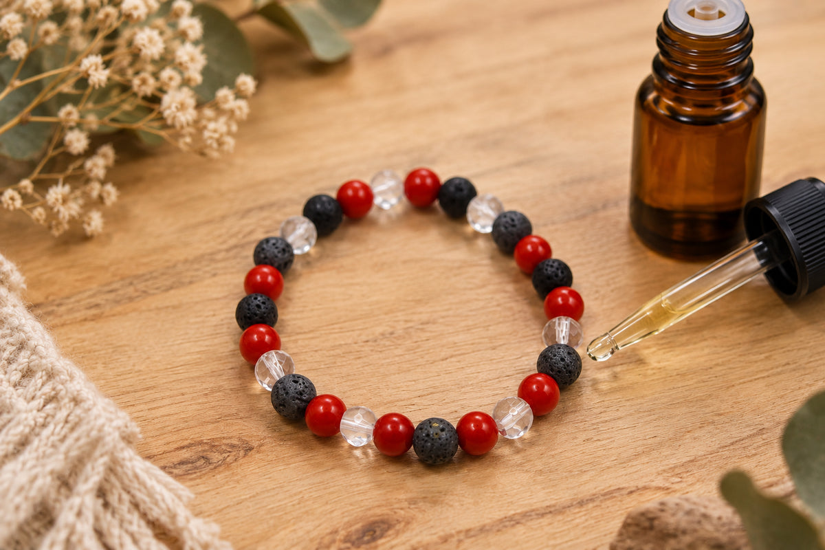 A beaded stretch bracelet featuring alternating red, black, and clear faceted beads, displayed on a neutral light gray background.