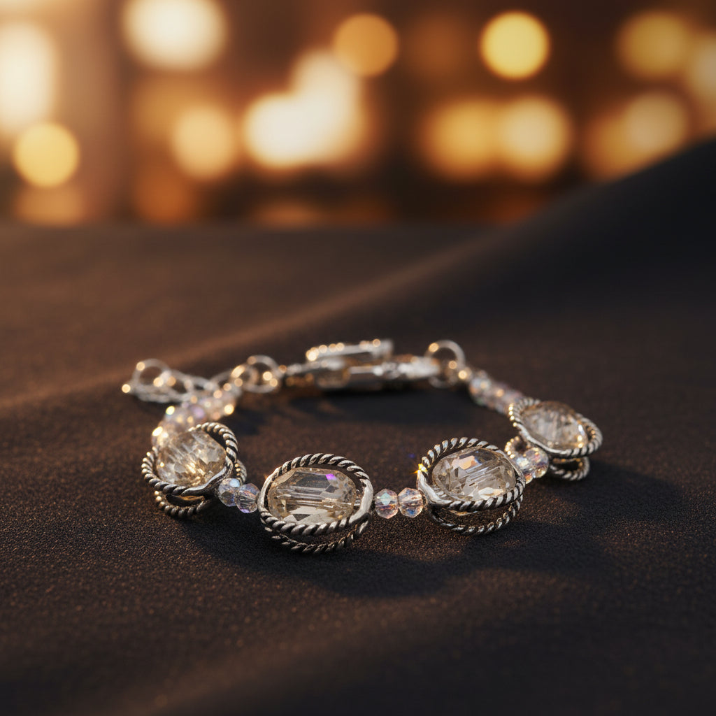 A silver-toned beaded bracelet with three large oval clear faceted gemstones and smaller clear beads, displayed on a plain light gray background.