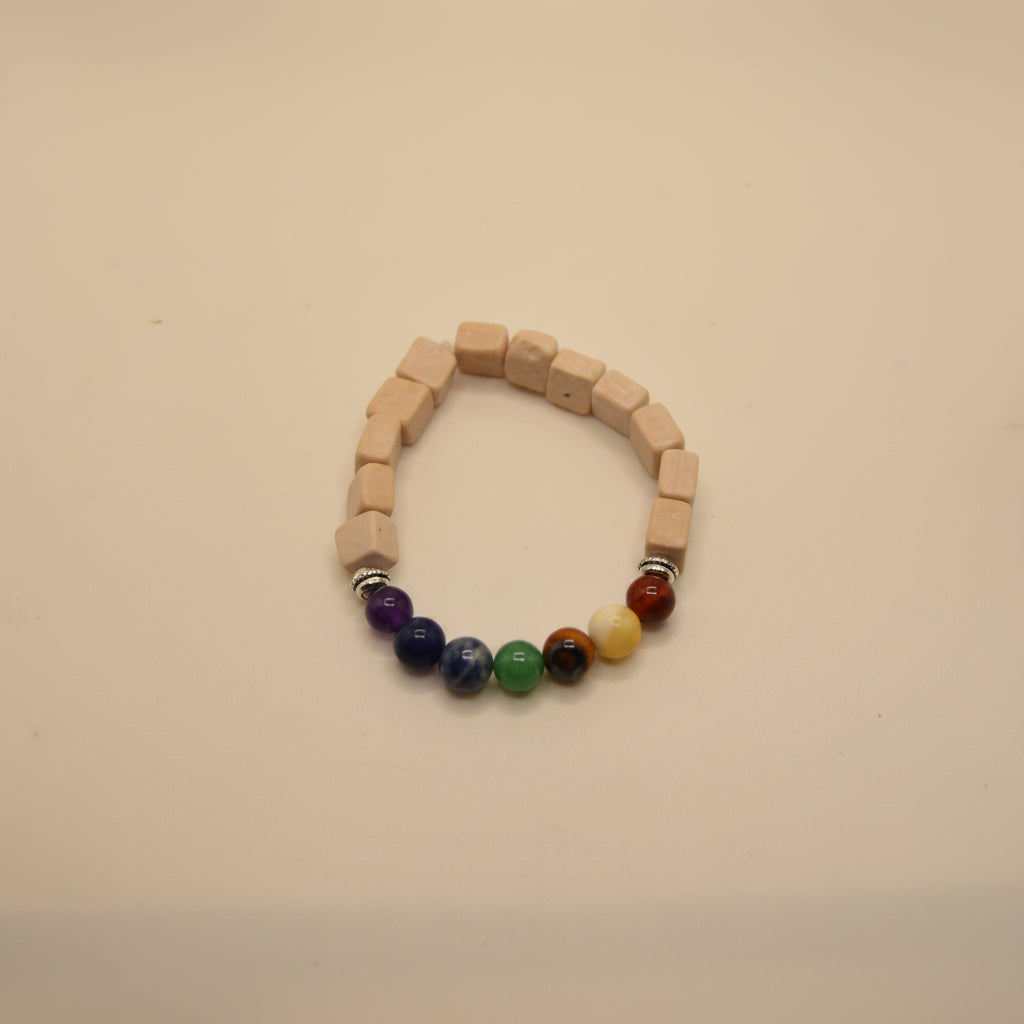 A beaded stretch bracelet made of light beige wooden cube beads, featuring a section of colorful round beads in purple, blue, green, yellow, orange, and red, displayed on a white background.
