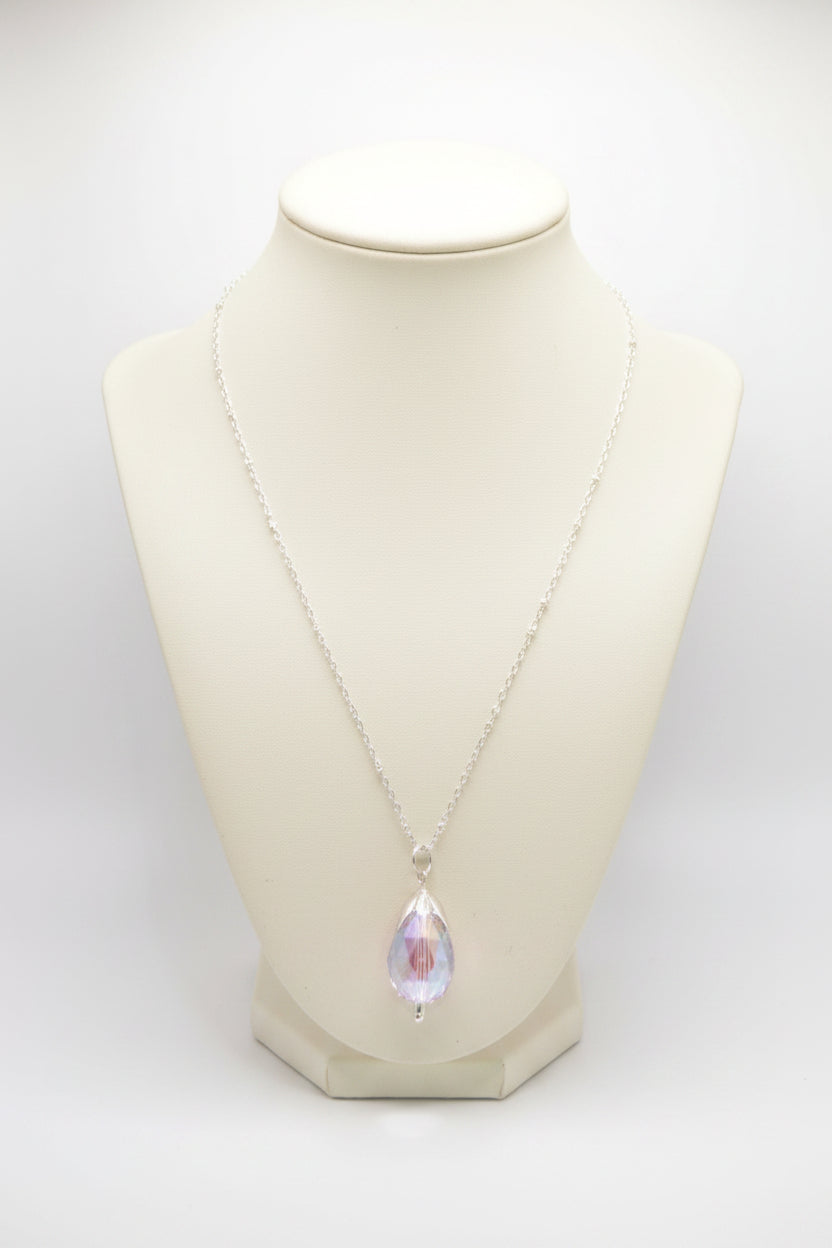A silver-tone chain necklace with a teardrop-shaped iridescent pendant displayed on a black velvet jewelry bust against a white background.
