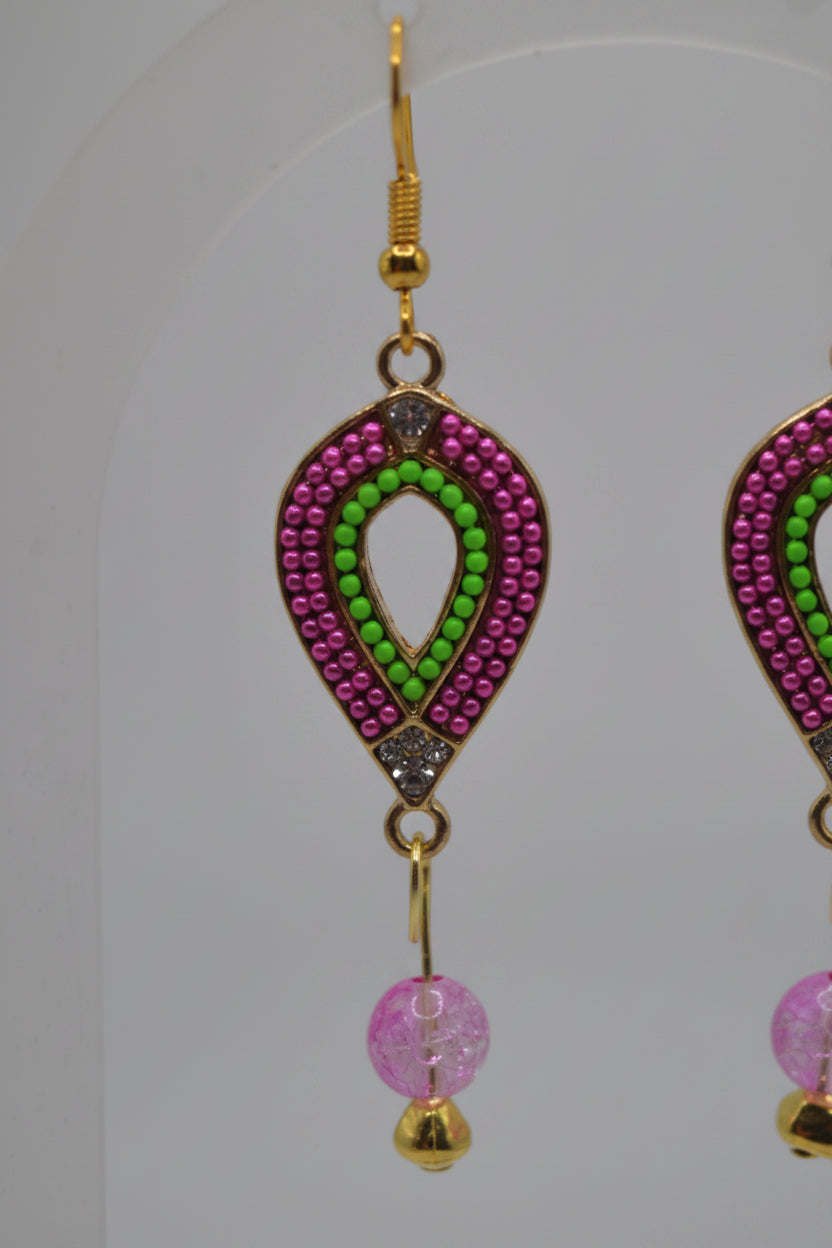 A pair of gold-tone dangle earrings with pink and green beaded teardrop-shaped charms and dangling pink faceted beads, displayed against a light gray background.