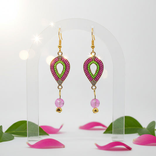A pair of gold-tone drop earrings with teardrop-shaped woven frames in pink and green, each hanging from a gold fishhook ear wire and ending in a faceted pink bead.