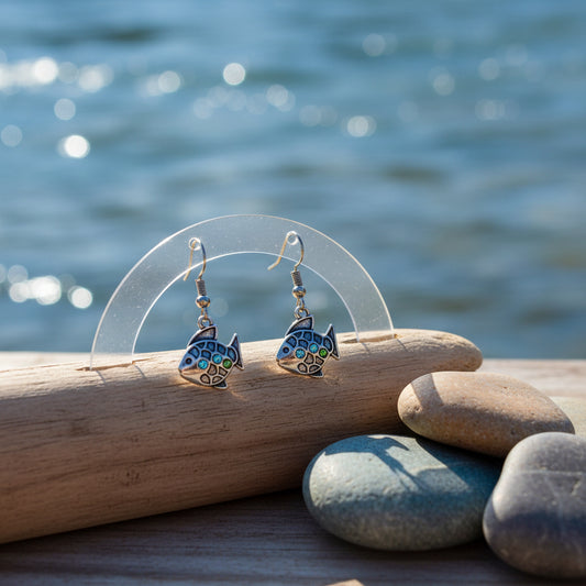 A pair of dangling fish-shaped earrings with silver-toned hooks and bodies, decorated with small iridescent rhinestones, shown against a plain light gray background.