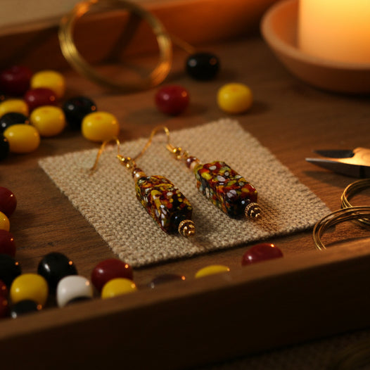 Colorful beaded earrings on a gray background