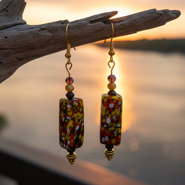 Colorful beaded earrings on a gray background