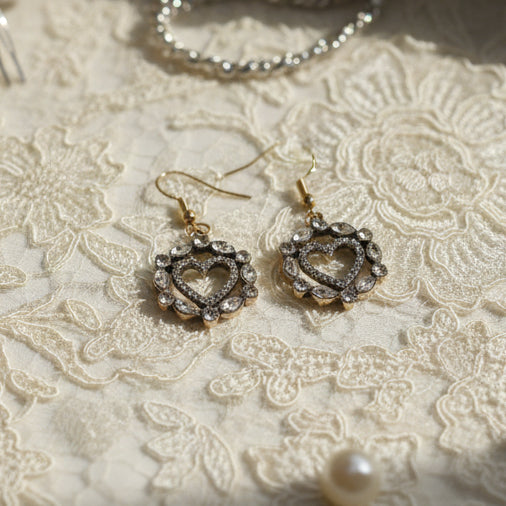 Heart-shaped earrings on a 'River Inspired' branded card against a white background