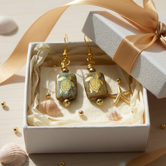Pair of earrings with turtle design on a gray background