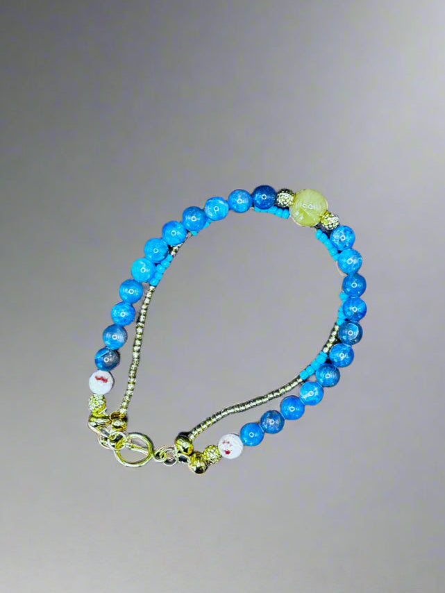 Double-Stranded Bracelet with Vibrant Blue Gemstones and Gold Accents