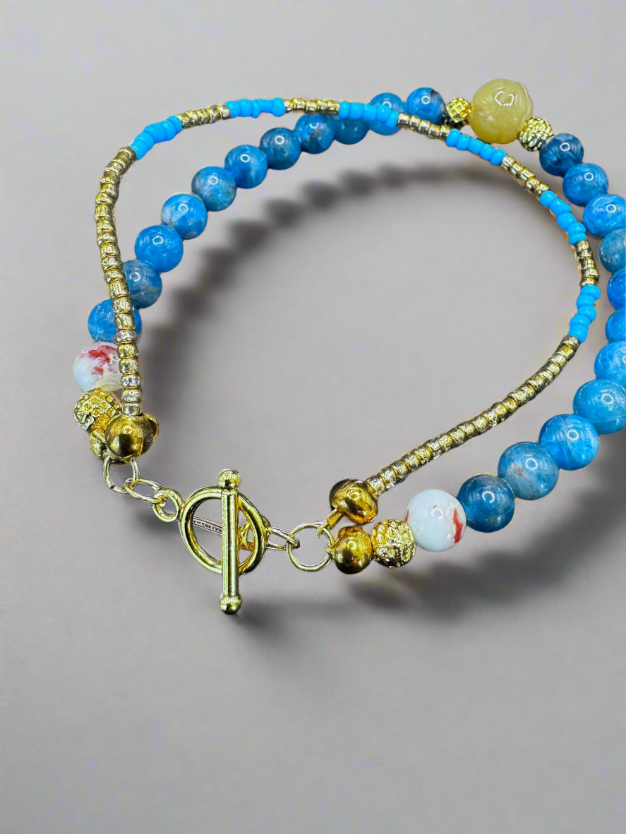 Double-Stranded Bracelet with Vibrant Blue Gemstones and Gold Accents