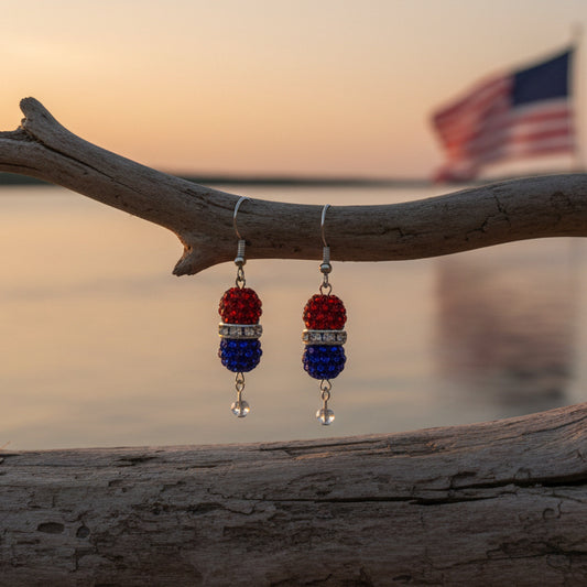 Pair of earrings with red and blue beads on a gray background