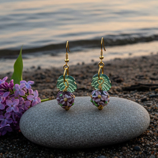 Pair of earrings with floral design on a gray background