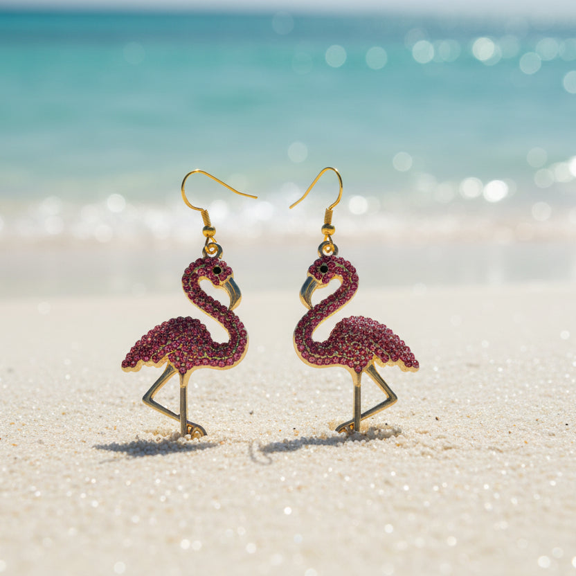 Flamingo-shaped earrings with pink and gold details on a gray background