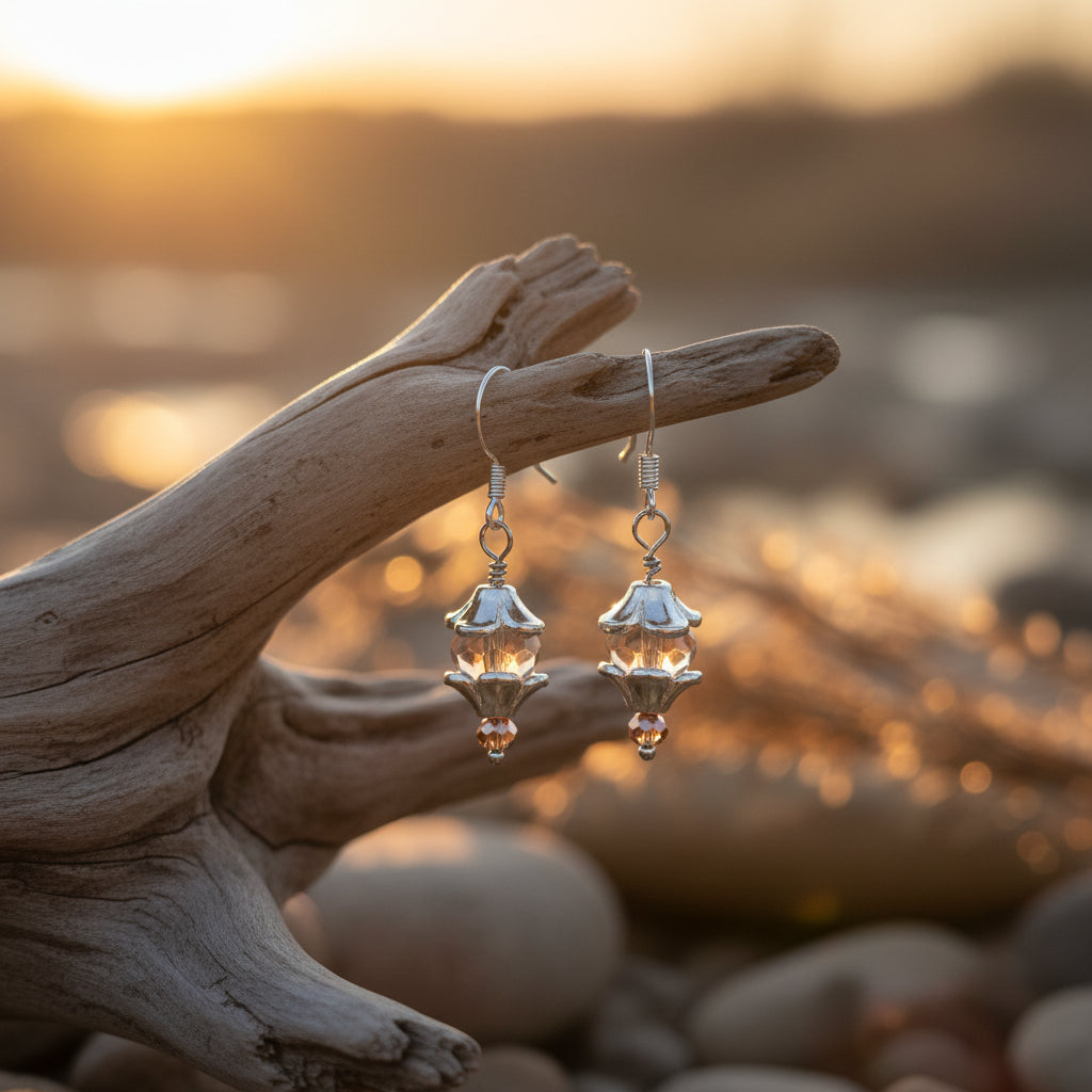 Silver earrings with brown beads on a gray background