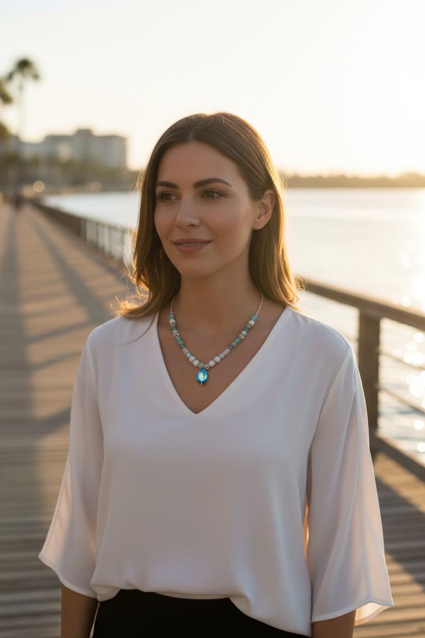 Necklace with blue and green beads on a white background