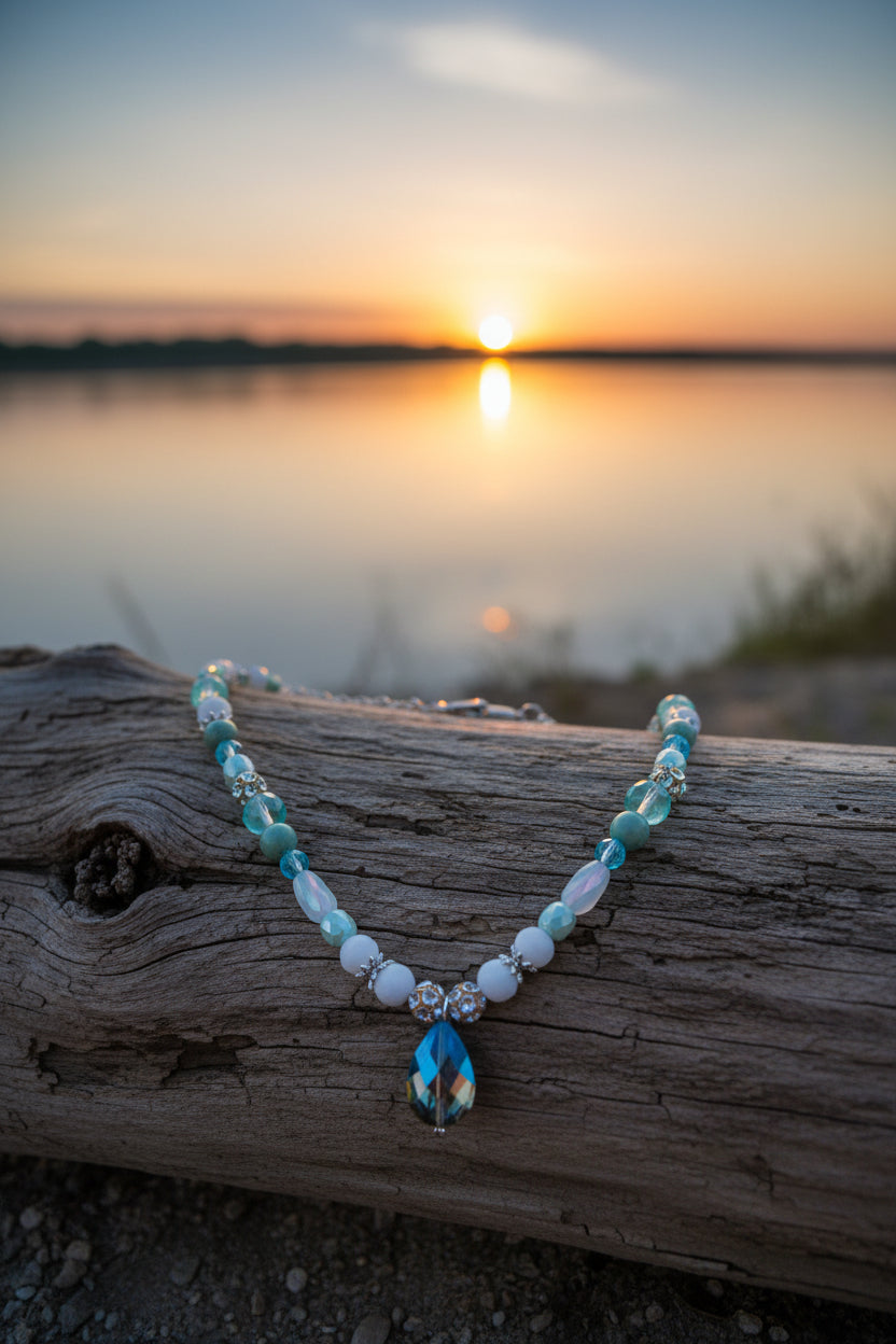 Necklace with beads and a teardrop-shaped pendant on a white background