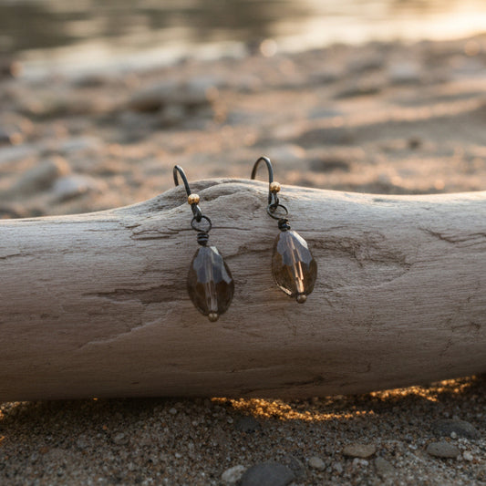 Pair of feather-shaped earrings on a white background