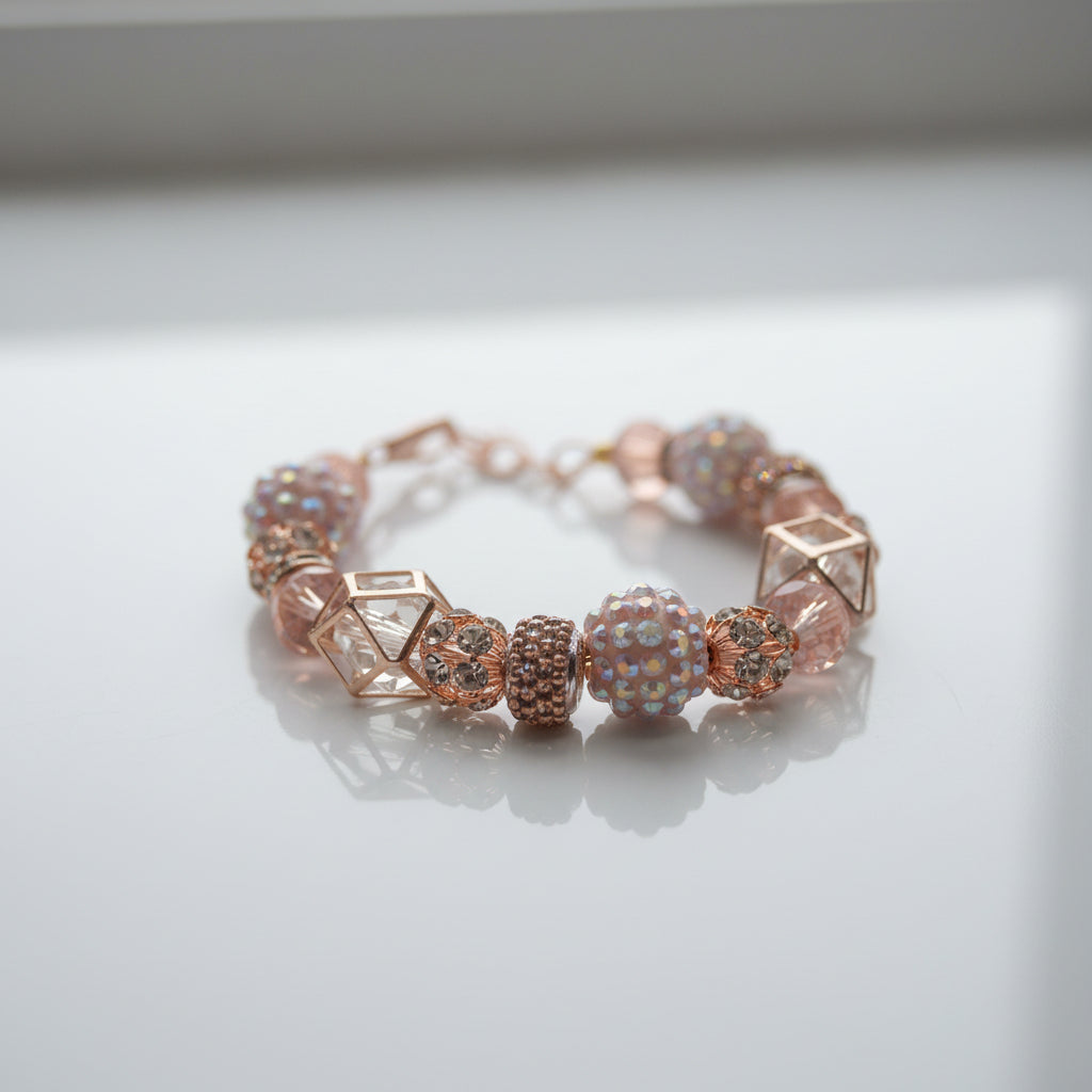 Beaded bracelet with pink and rose gold colors on a gray background