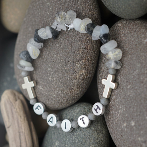 Bracelet with beads and crosses on a gray background