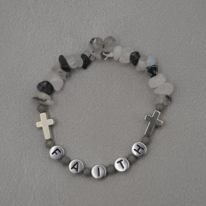 Bracelet with beads and crosses on a gray background
