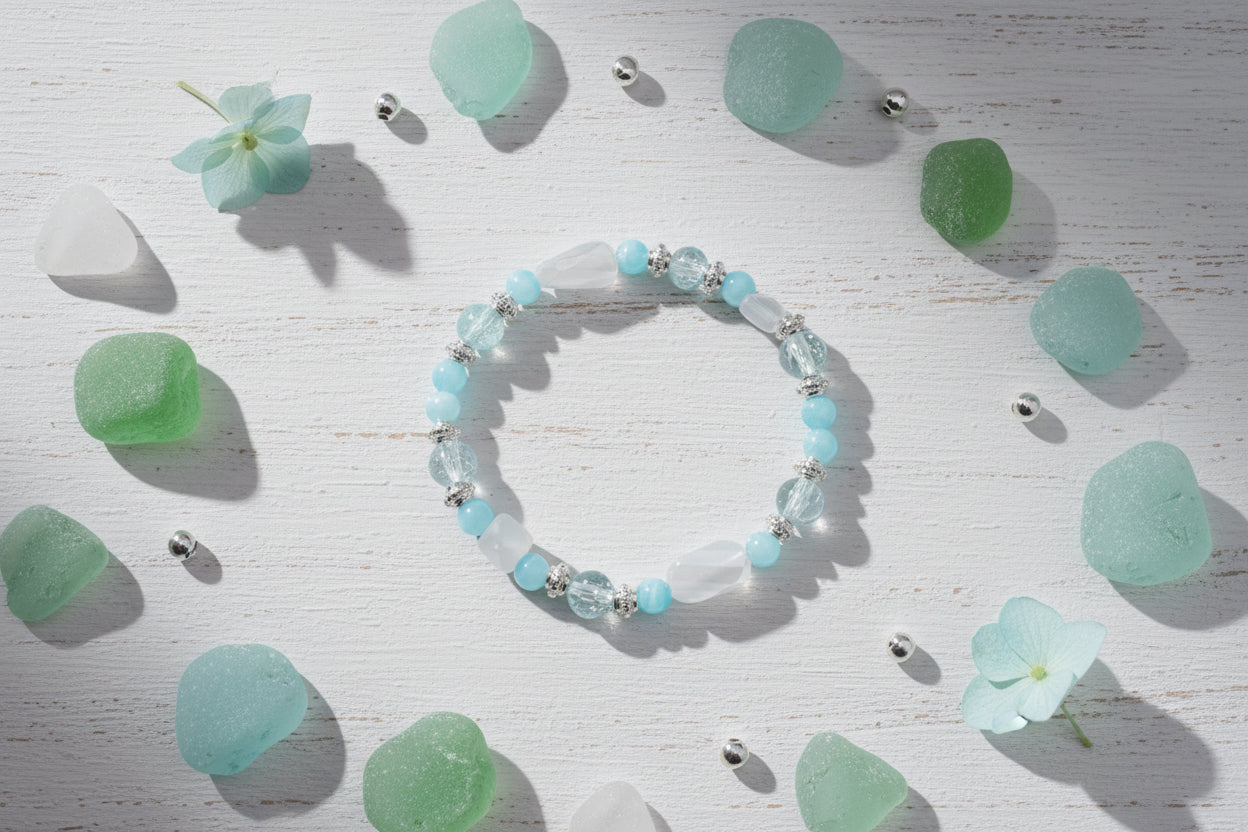 Beaded bracelet with blue and clear beads on a gray background