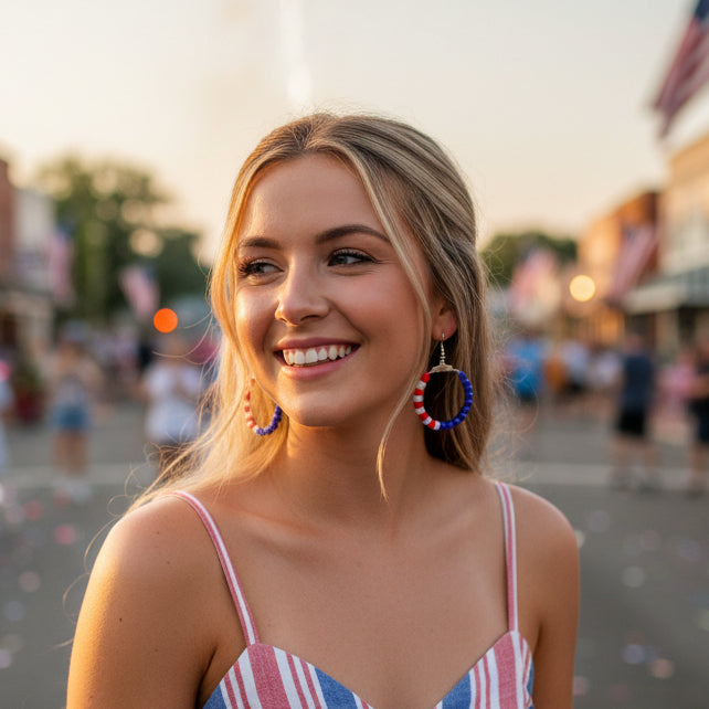 Pair of hoop earrings with red and blue beads on a gray background