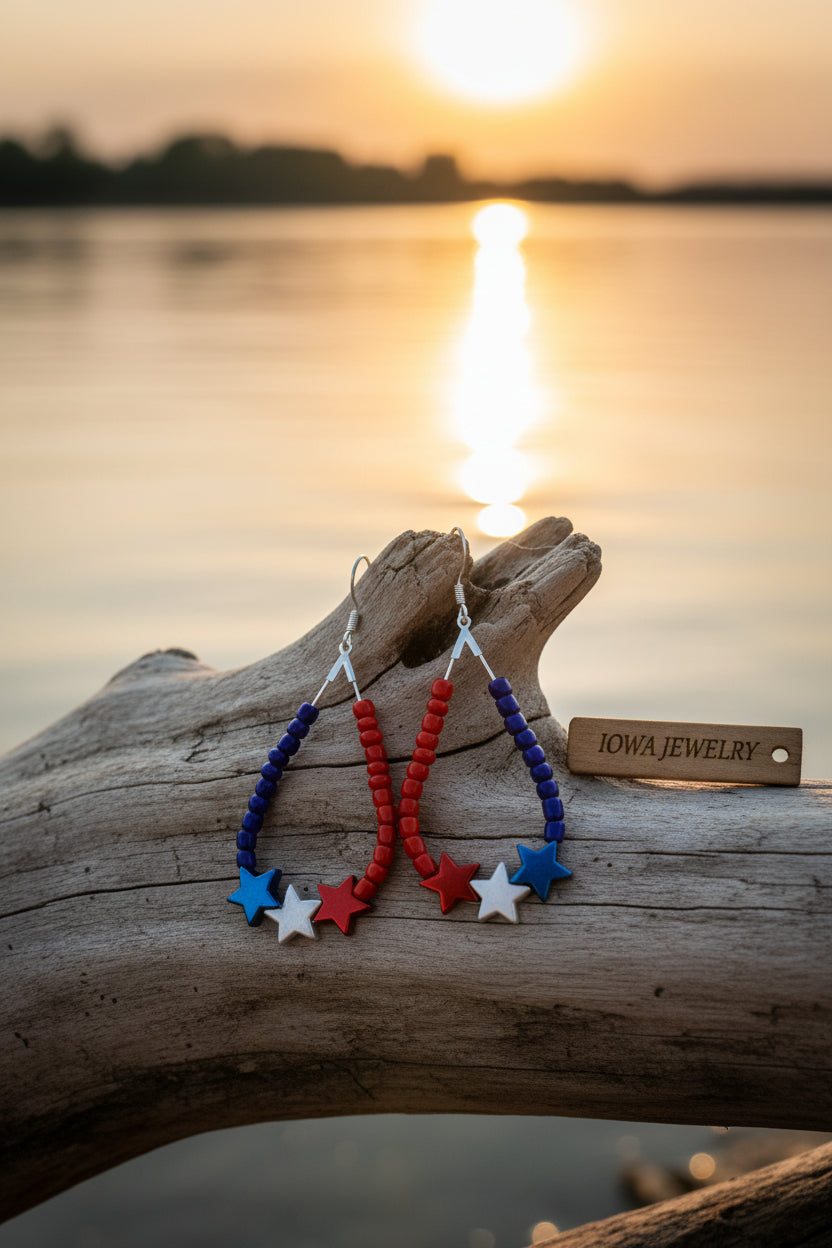 Colorful beaded earrings with star charms on a gray background