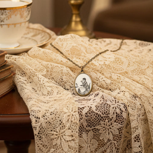 Gold necklace with a pendant on a black mannequin bust