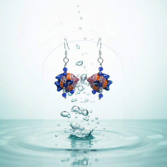 Pair of fish-shaped earrings with colorful beads on a gray background