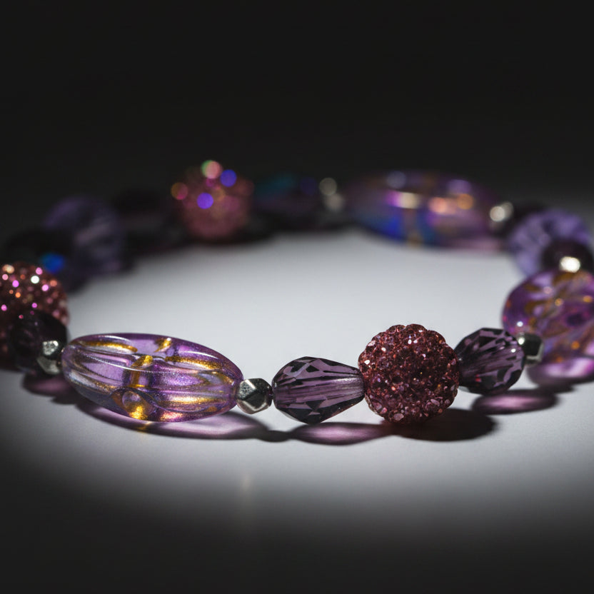 Necklace with purple and pink beads on a gray background