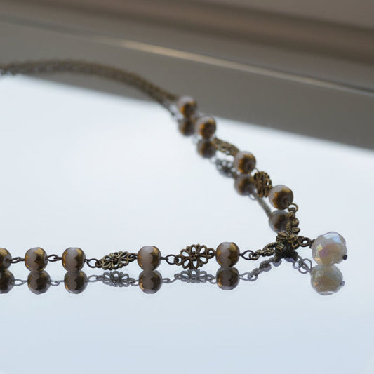 Necklace with beads and chain on a white background